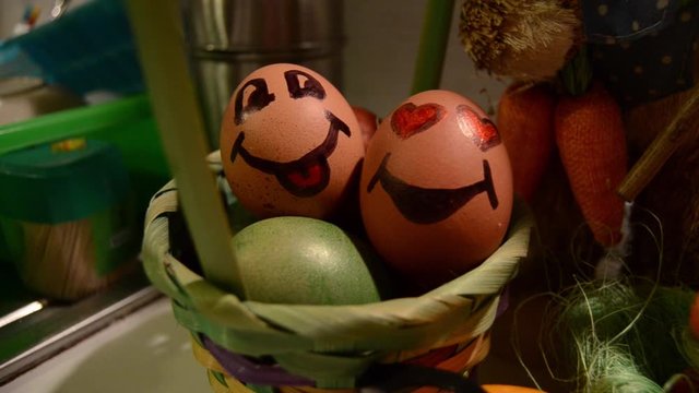Easter egg with smiley faces in the basket. Traditional orthodox decoration painted eggs. slow tilt down shot