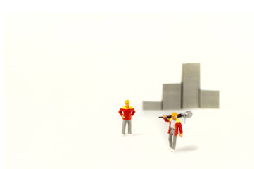 Selective focus miniature workers team with blur building background with copy space.