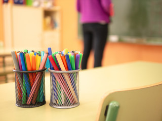 two pen holders with marker pens