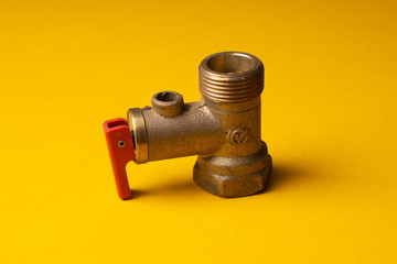 Bronze Check Valve. Non-return valve for water in the electric water heater system. On a yellow background.