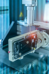 The multi-axis CMM machine measure the aluminum mobile phone part .