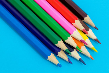 Multi color pencils on a blue background.  School concept