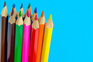 Multi color pencils on a blue background.  School concept