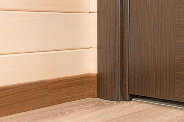 The junction of wooden walls, floor and interior doors