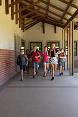 Group of schoolchildren running in an outdoor corridor at elementary school