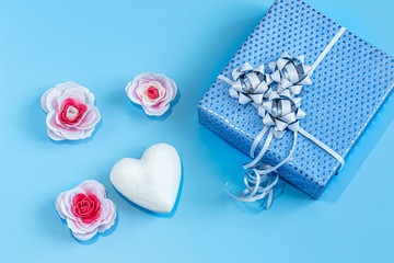 Gift box Packed in blue paper on a blue background .