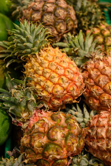 Exotic fruits, fresh ripe sweet pinapples, tropical food background