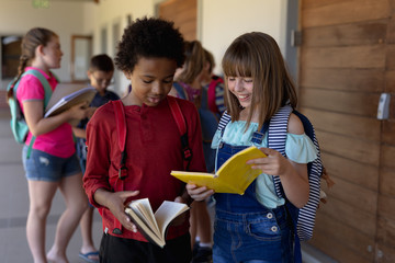 Schoolgirls standing in an outdoor corridor at elementary school 