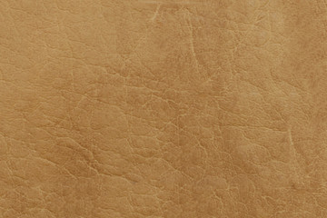 Brown genuine leather. Textured surface with a pattern.