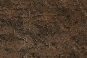 Brown leather. Textured surface with a pattern.