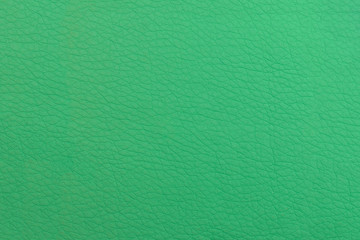 Green leather background. Textural surface with a pattern.