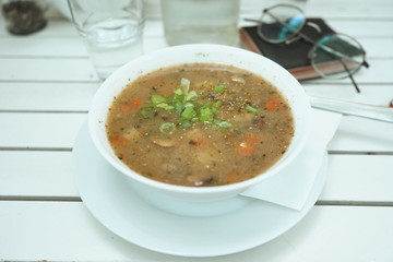 Vegetable soup on white wooden table