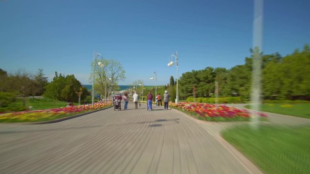 Hyper lapse of walking pepople in spring park. Nature and travel scene.