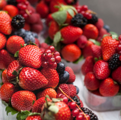 Fototapeta premium Berries in plastic baskets. Fresh strawberries, raspberries, blackberries, blueberries in takeaway cups. market. close-up
