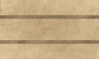 Fototapeta premium Traces of car treads on a sandy background.