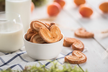 Crispy cookies with milk on light background