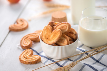 Crispy cookies with milk on light background