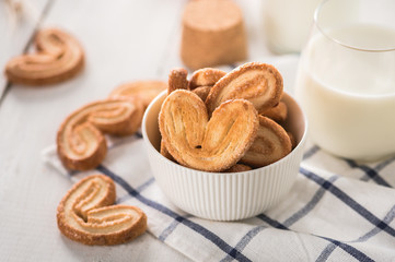 Crispy cookies with milk on light background