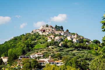 View of Motovun or Montona. Village in central Istria, Croatia. It is situated on a green hill with houses scattered all over the hill.