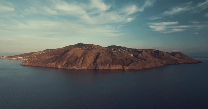 Drone panoramic aerial view of the vulcano island in the Mediterranean sea in Lipari, Aeolian islands, Sicily, Italy in sunset time. Drone is stable above Mediterranean blue sea. 