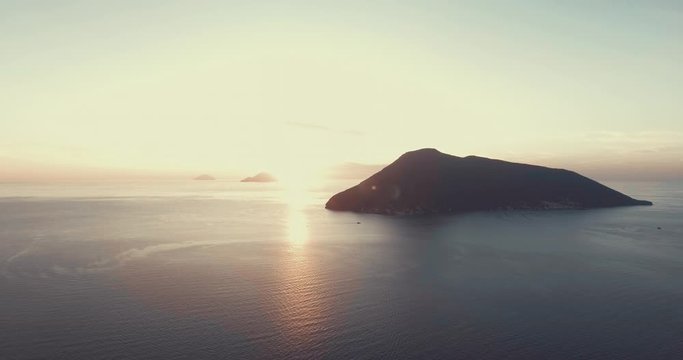 Drone panoramic aerial view of the vulcano island in the Mediterranean sea in Lipari, Aeolian islands, Sicily, Italy in sunset time. Crazy sunset colors in front drone view