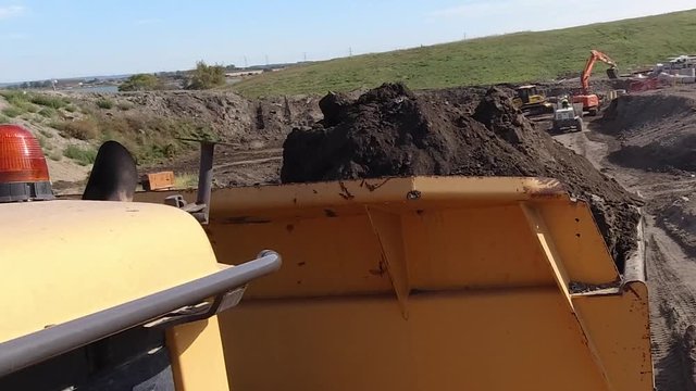 Action cam shot of a dumper truck reversing ready to tip earth on a construction site