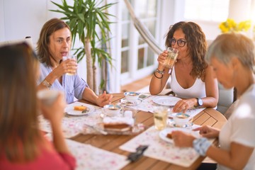 Young beautiful girl smiling happy and confident sitting dinking cup of coffee at terrace