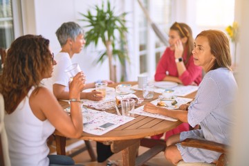 Young beautiful girl smiling happy and confident sitting dinking cup of coffee at terrace