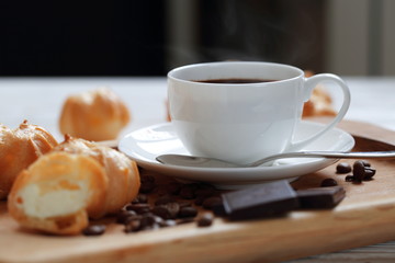 Profiteroles with coffee and chocolate on a white background
