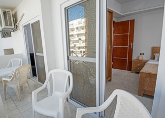 Terrace balcony with chairs in tropical luxury apartment resort