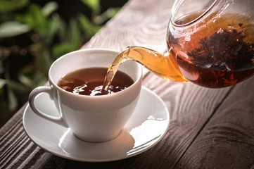 A Cup of freshly brewed black tea on dark background