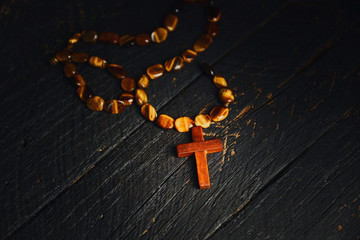 Christian cross necklace on darck background - as a symbol of the beginning of Great Lent,  Toned image