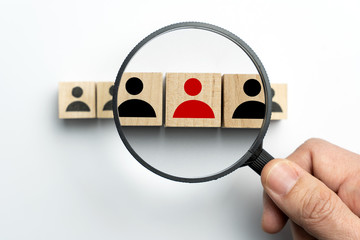 Searching for talent or looking for employee concept using magnifying glass and wooden cube with...