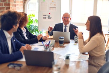 Group of business workers smiling happy and confident. Speaking with smile on face working together at the office.
