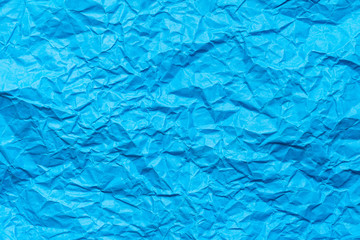 Blue crumpled paper background or texture in detail