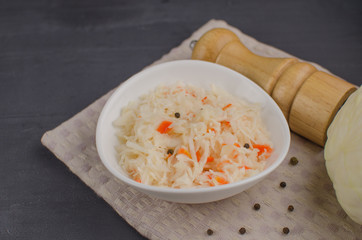 sauerkraut and carrots in a plate. horizontal view from above, rustic style. Fermented food. Copy space.