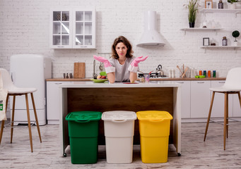 Young girl sorting garbage at the kitchen. Concept of recycling. Zero waste