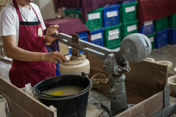 Fototapeta na wymiar hands working clay on potter's wheel, Lampang in Thailand