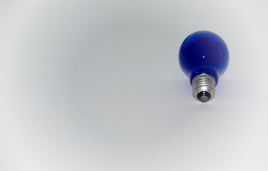 Light blue bulb on a gradient gray background