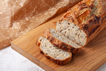 Pooppy cake with apple on wooden plate. Sliced pie.
