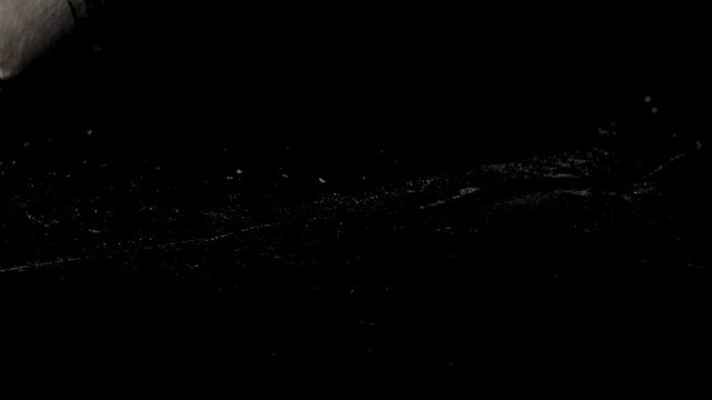 Cocaine line snorted from the black reflective surface using the rolled money. Close up shot. Cocaine Addiction and Abuse Concept.