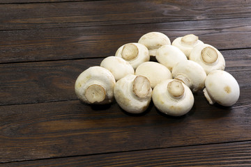 Champignons on a wooden table. Wooden background. Meadow mushroom.