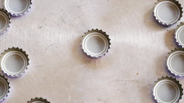 close up bottle cap on aluminum plate