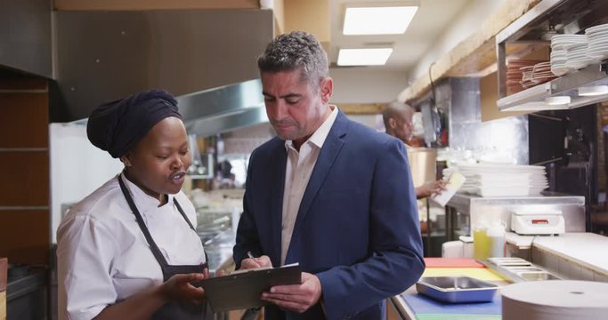 Caucasian man talking to a cook