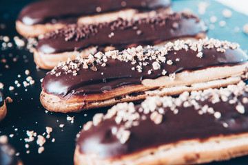  Traditional french eclairs with chocolate. Tasty dessert. Home made cake eclairs  Sweet. Dessert. Pastry filled with cream. Chocolate icing.