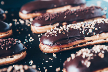  Traditional french eclairs with chocolate. Tasty dessert. Home made cake eclairs  Sweet. Dessert. Pastry filled with cream. Chocolate icing.