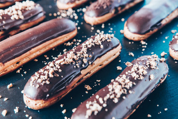  Traditional french eclairs with chocolate. Tasty dessert. Home made cake eclairs  Sweet. Dessert. Pastry filled with cream. Chocolate icing.
