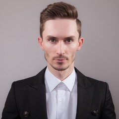 Handsome young elegant man studio portrait.