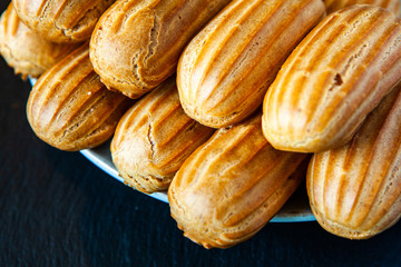  Traditional french eclairs with chocolate. Tasty dessert. Home made cake eclairs  Sweet. Dessert. Pastry filled with cream. Chocolate icing.