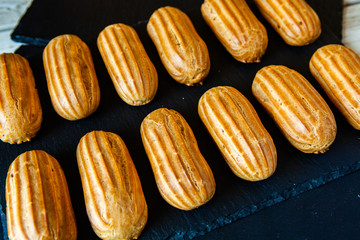  Traditional french eclairs with chocolate. Tasty dessert. Home made cake eclairs  Sweet. Dessert. Pastry filled with cream. Chocolate icing.